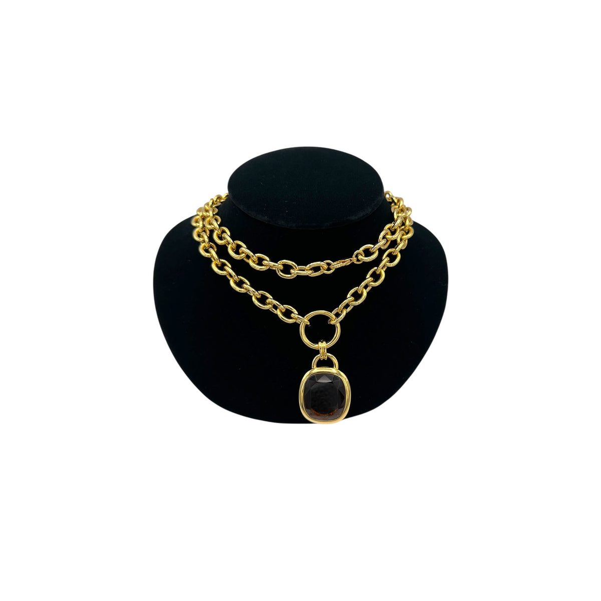 Vintage Joan Rivers gold link necklace with smoky brown topaz glass pendant displayed on black velvet bust.