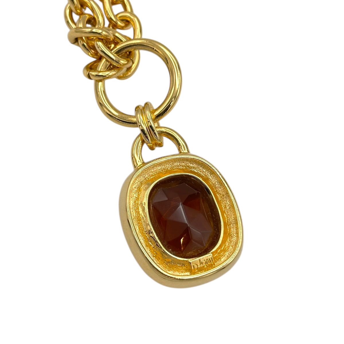 Back view of pendant of Vintage Joan Rivers gold link necklace with smoky brown topaz glass pendant displayed on white background.