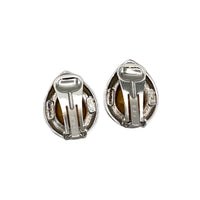Back view of Vintage Kenneth Jay Lane clear teardrop rhinestone clip-on earrings with black enamel border displayed on white background.
