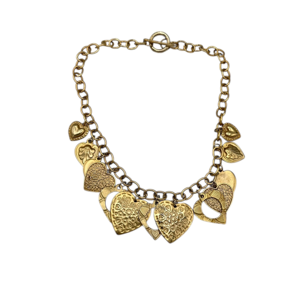 Vintage gold heart charm necklace with textured hearts and link chain displayed on white background.
