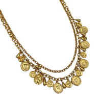 Close up of coins of Vintage gold layered Roman coin charm necklace with medallions and teardrop accents displayed on white background.