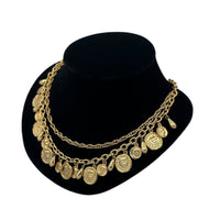 Side view of Vintage gold layered Roman coin charm necklace with medallions and teardrop accents displayed on black velvet bust.