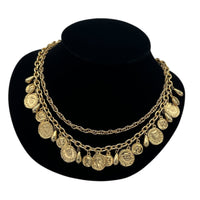 Close up view of Vintage gold layered Roman coin charm necklace with medallions and teardrop accents displayed on black velvet bust.