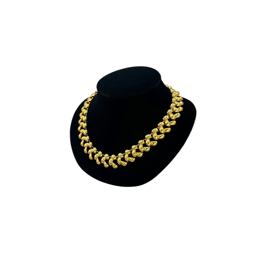 Side view of Anne Klein II vintage gold link statement necklace on display bust.