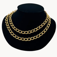 Close up view of Erwin Pearl textured gold curb link vintage chain necklace double wrapped displayed black bust.