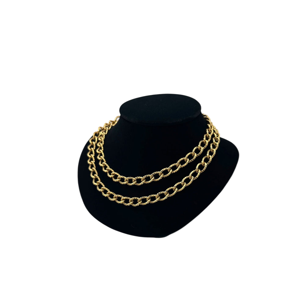 Side view of Erwin Pearl textured gold curb link vintage chain necklace double wrapped displayed black bust.