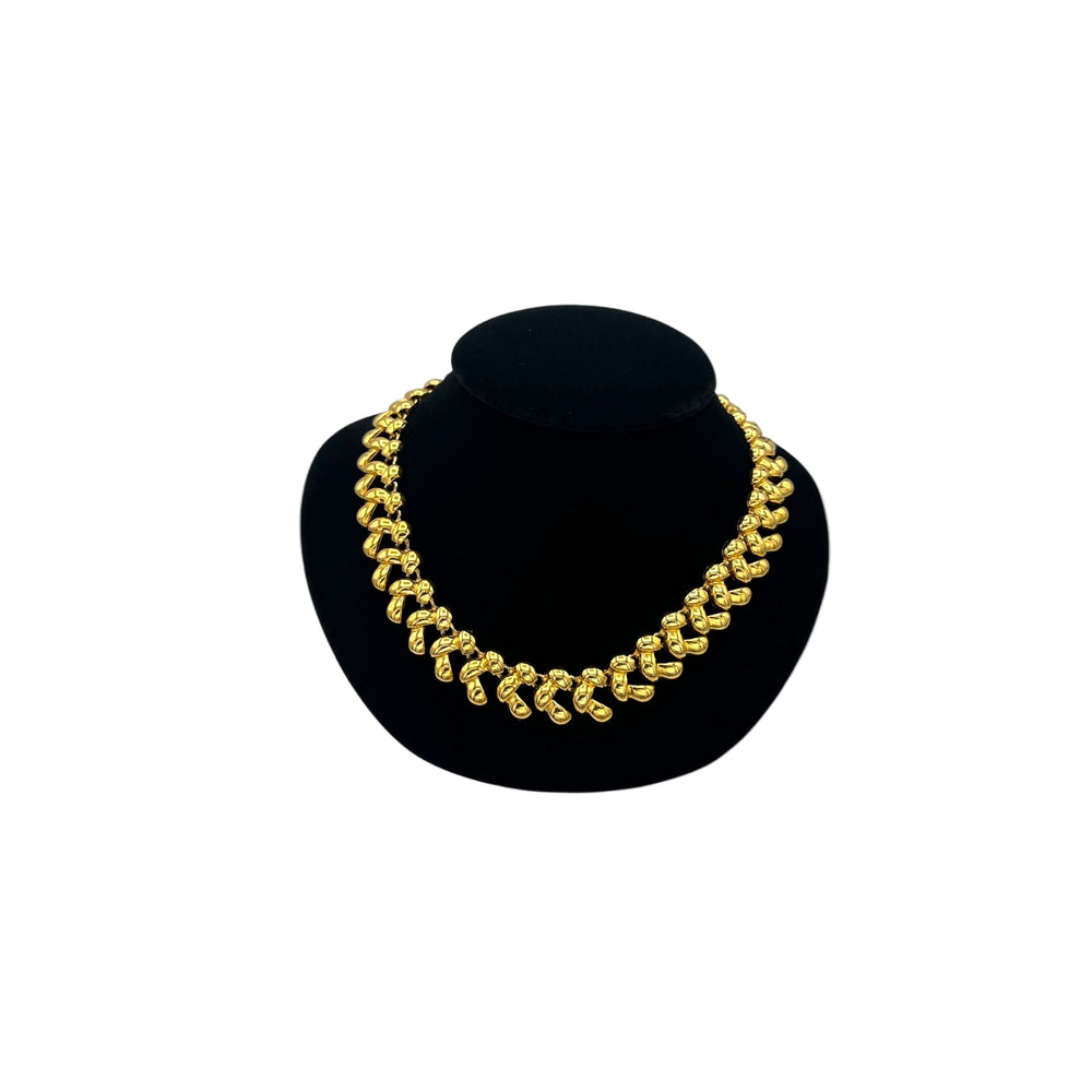 Anne Klein II vintage gold link statement necklace on display bust.