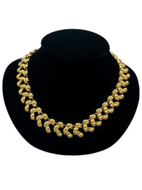 Close up view of Anne Klein II vintage gold link statement necklace on display bust.