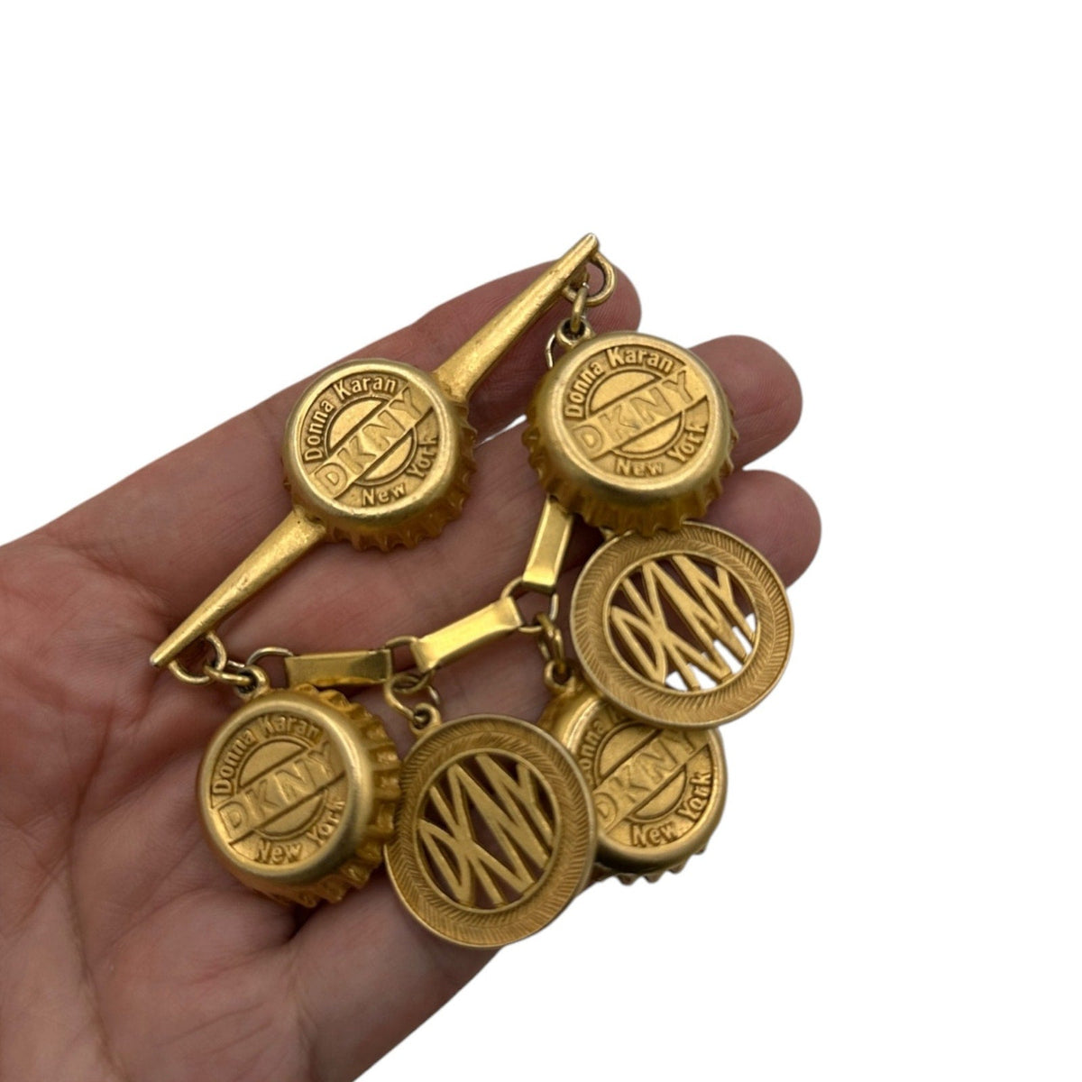 Brooches & PinsDonna Karan DKNY Bottle Cap Dangle Charm Brooch
