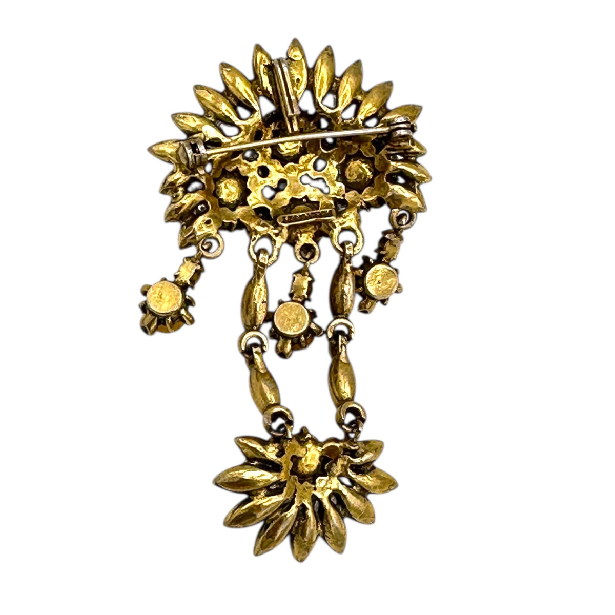 Back view of Hollycraft Victorian Revival brooch with deep red rhinestones, faux pearls, and cascading gold-tone dangles – vintage statement jewelry shown on white background.