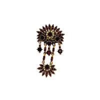 Hollycraft Victorian Revival brooch with deep red rhinestones, faux pearls, and cascading gold-tone dangles – vintage statement jewelry shown on white background.