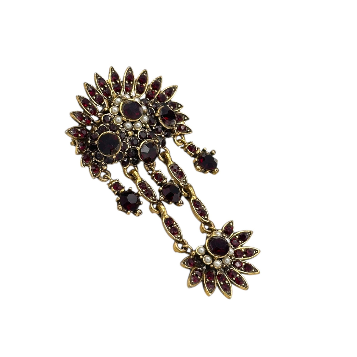 Side view of Hollycraft Victorian Revival brooch with deep red rhinestones, faux pearls, and cascading gold-tone dangles – vintage statement jewelry shown on white background.