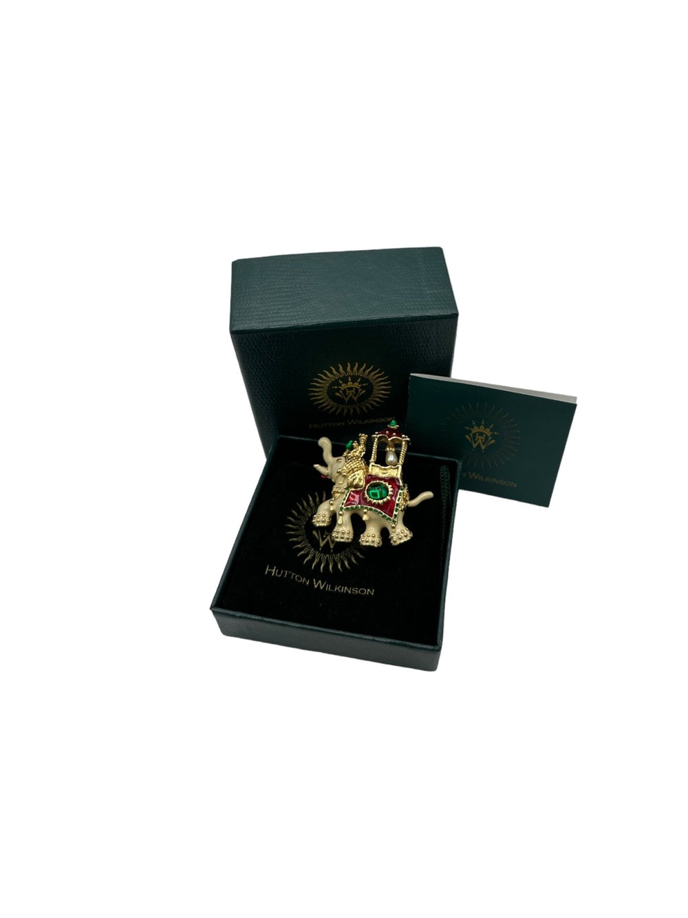 Hutton Wilkinson gold-tone enamel elephant brooch with red and green details, faux emerald and pearl accent.