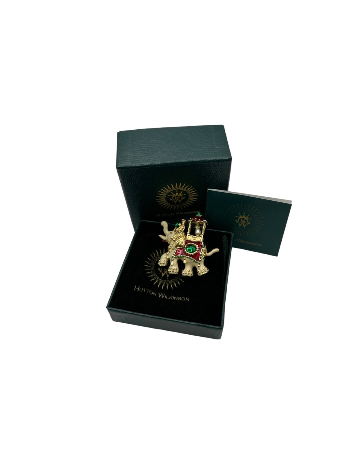 Hutton Wilkinson gold-tone enamel elephant brooch with red and green details, faux emerald and pearl accent.