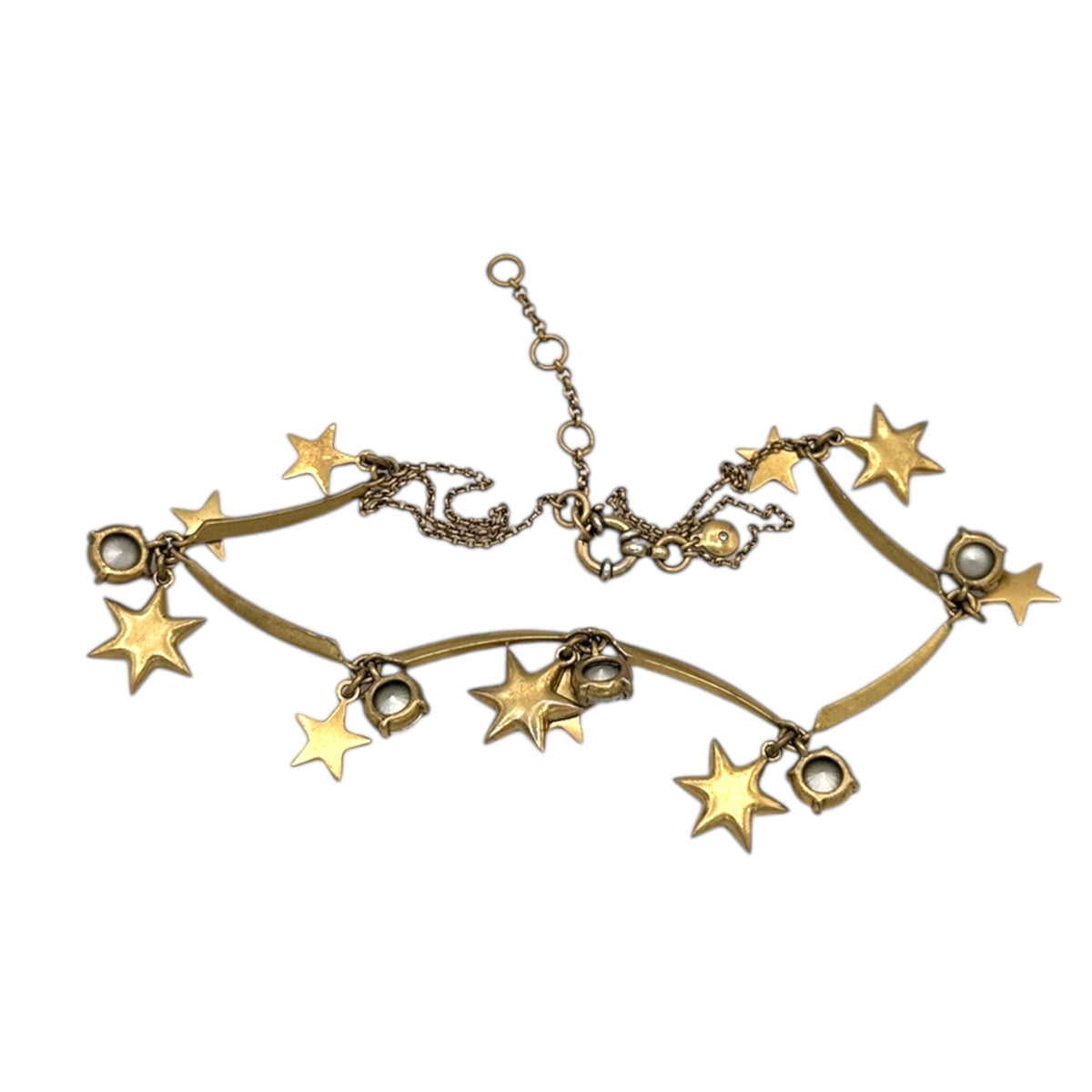 Back view of J. Crew vintage antiqued gold star charm necklace with rhinestone accents displayed on white background.