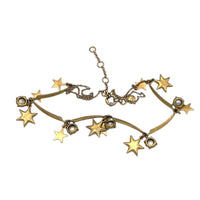 Back view of J. Crew vintage antiqued gold star charm necklace with rhinestone accents displayed on white background.