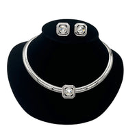 Close up view of Vintage Joan Rivers silver omega necklace and matching clear rhinestone clip-on earring set on black bust.