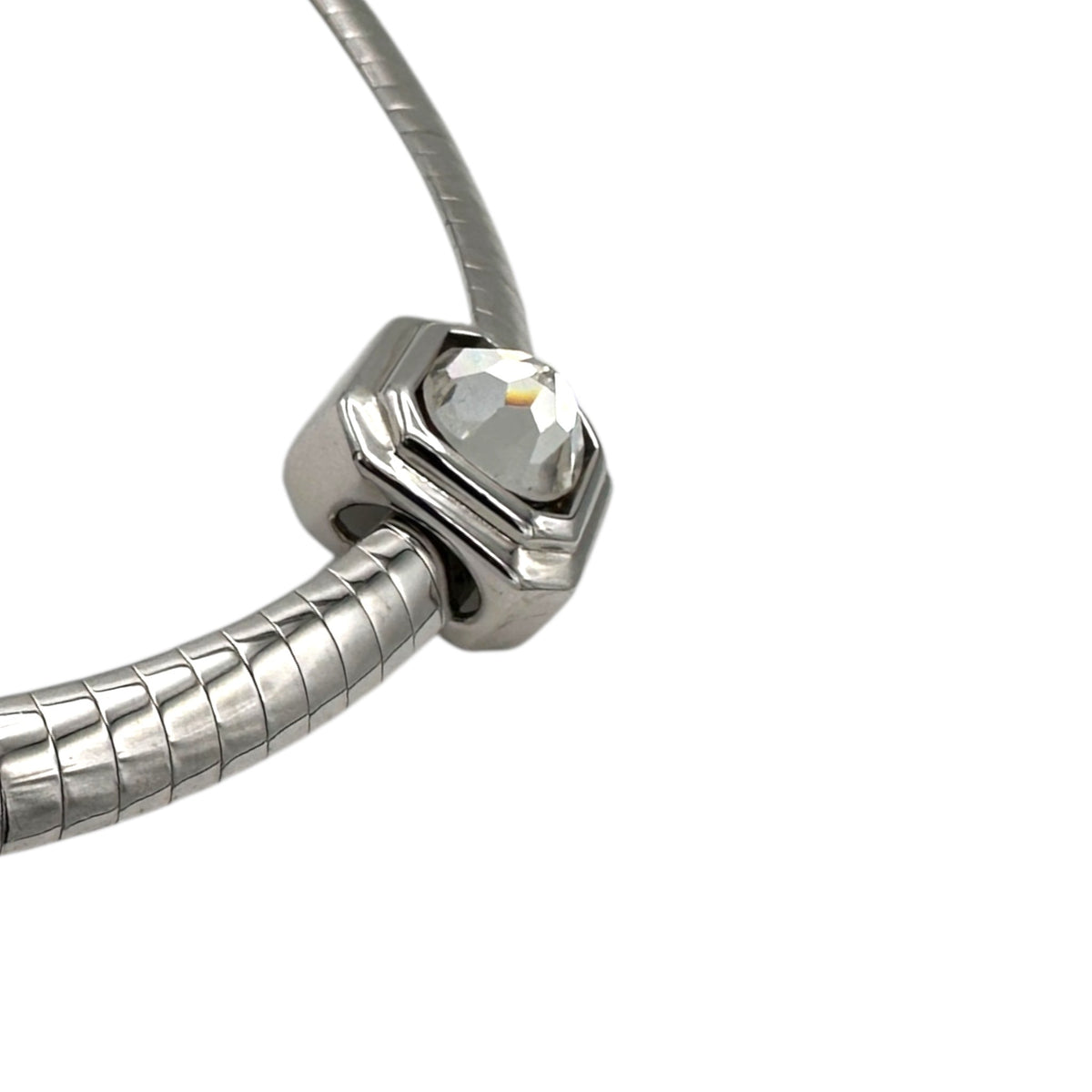 Side view of Side view of Vintage Joan Rivers silver pendant set on white background.