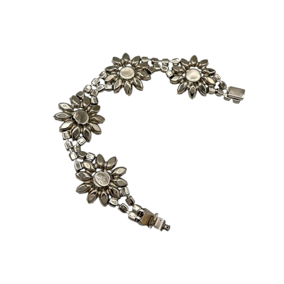 Back view of Kirks Folly vintage bracelet with clear and black rhinestone flower design on white background.