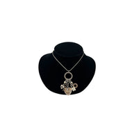 Vintage Liz Palacios San Francisco silver charm necklace with heart and key pendants displayed on black velvet bust.