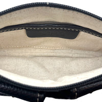 Interior bottom view of Vintage Michael Kors black pebbled leather Roadie bag with gold hardware and dual front pockets displayed on white background.