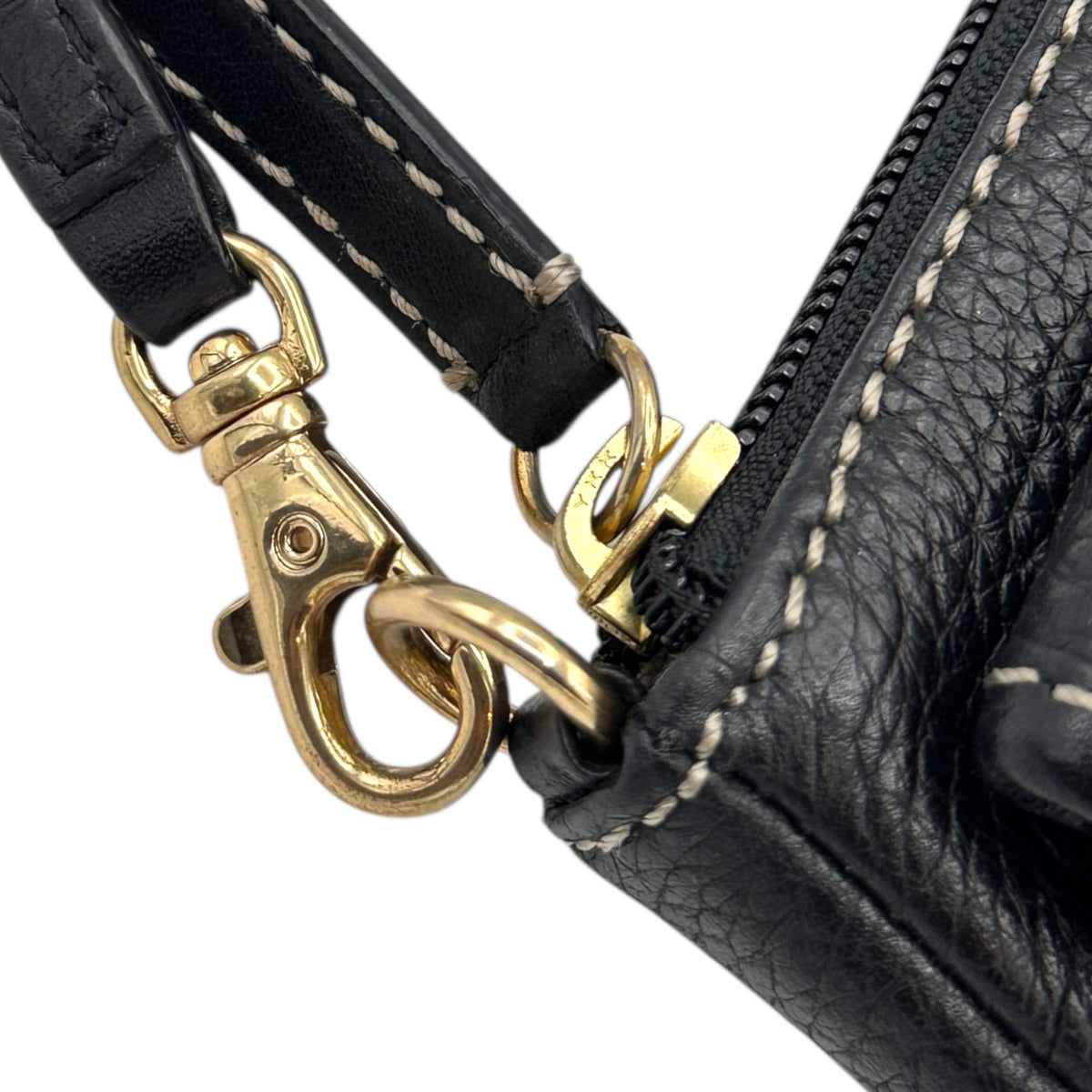 Zipper and clasp view of Vintage Michael Kors black pebbled leather Roadie bag with gold hardware and dual front pockets displayed on white background.