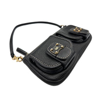 Side view of Vintage Michael Kors black pebbled leather Roadie bag with gold hardware and dual front pockets displayed on white background.