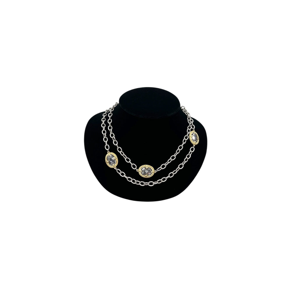 Vintage mixed metal long cable chain necklace with gold bezel-set oval crystals displayed on black velvet bust.