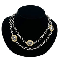 Close up view of Vintage mixed metal long cable chain necklace with gold bezel-set oval crystals displayed on black velvet bust.