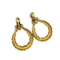 Back view of Monet vintage gold twisted swirl doorknocker clip-on earrings displayed on white background.