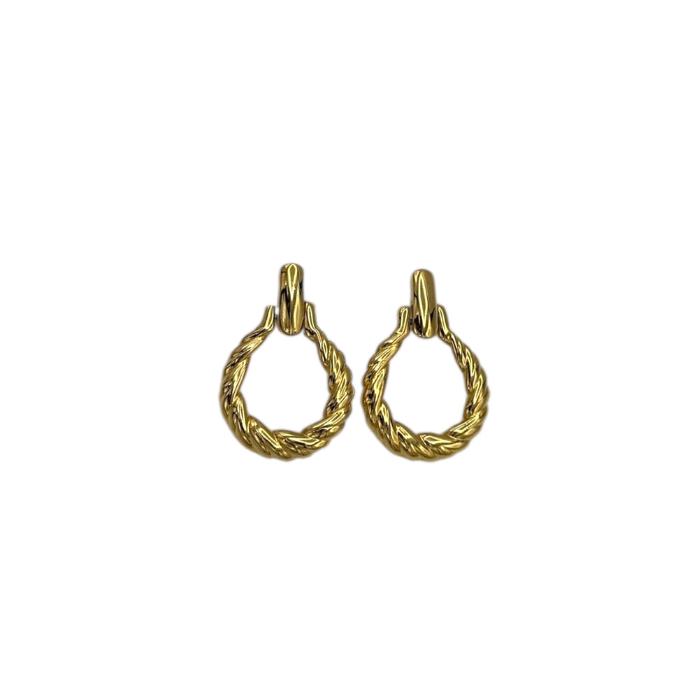 Monet vintage gold twisted swirl doorknocker clip-on earrings displayed on white background.