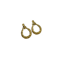 Side view of Monet vintage gold twisted swirl doorknocker clip-on earrings displayed on white background.