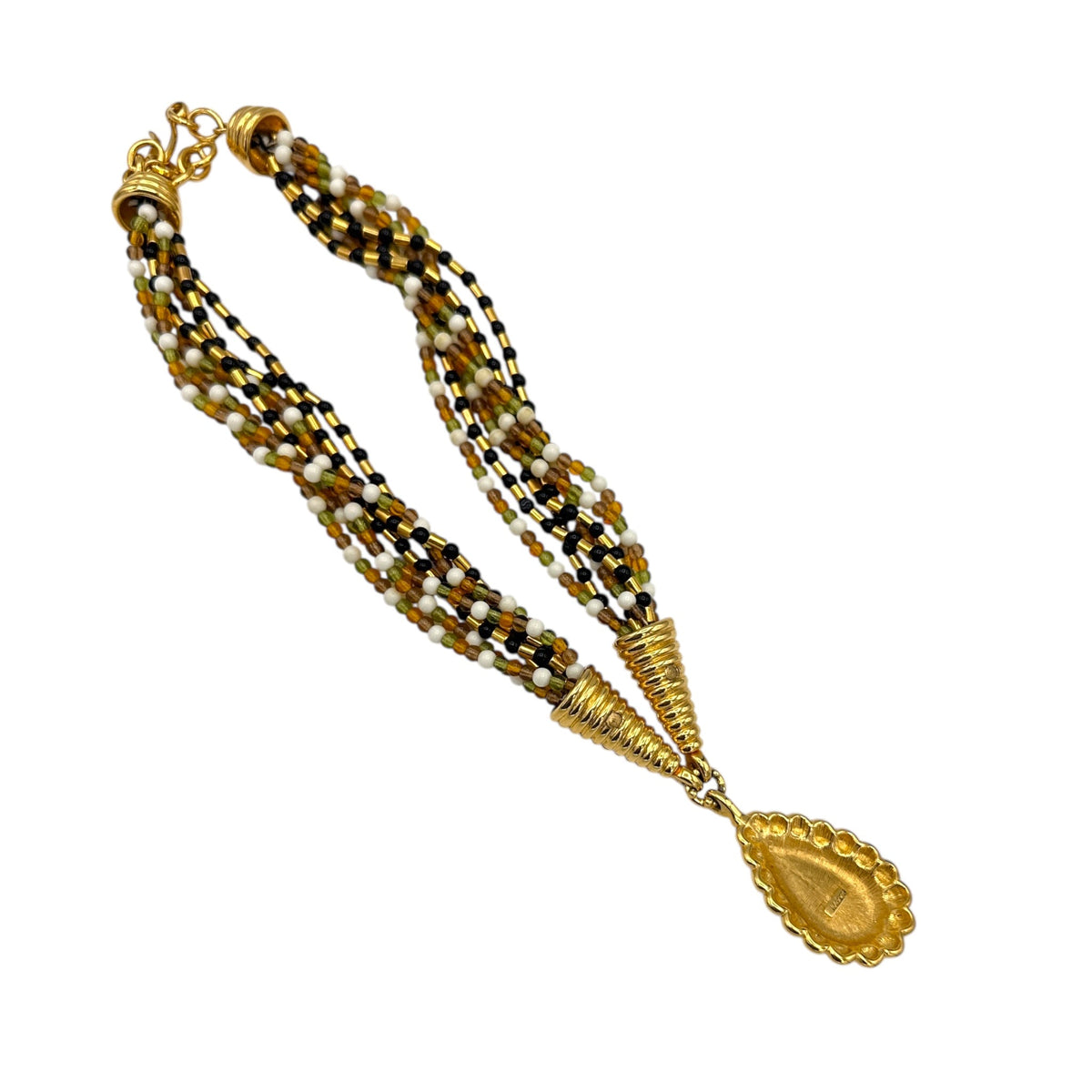 Back view of Monet vintage gold multi-strand beaded necklace with a brown teardrop pendant and gold accents on white background.