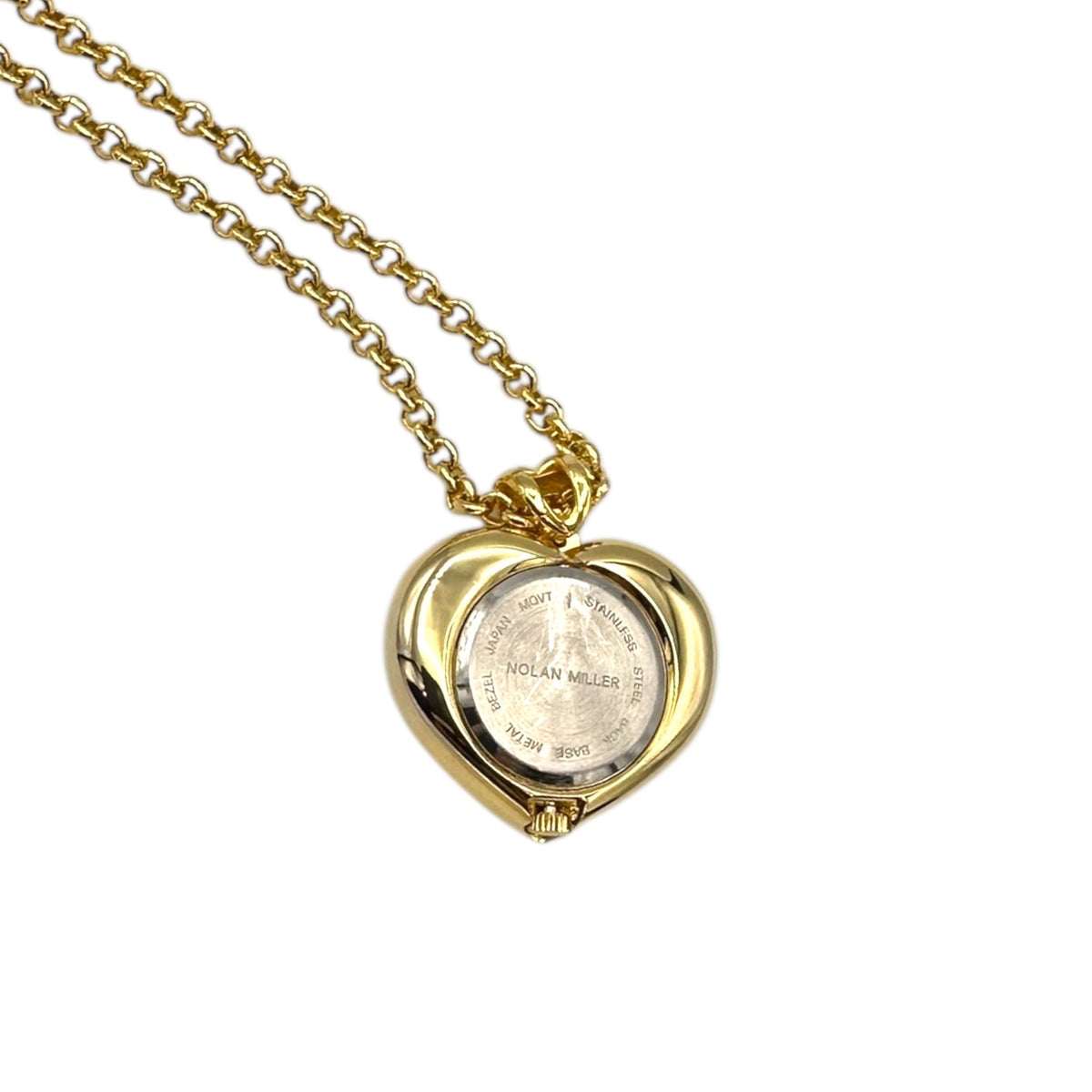 Back view of watch of Vintage Nolan Miller gold heart pendant watch with rhinestone accents on long cable chain displayed on white background.