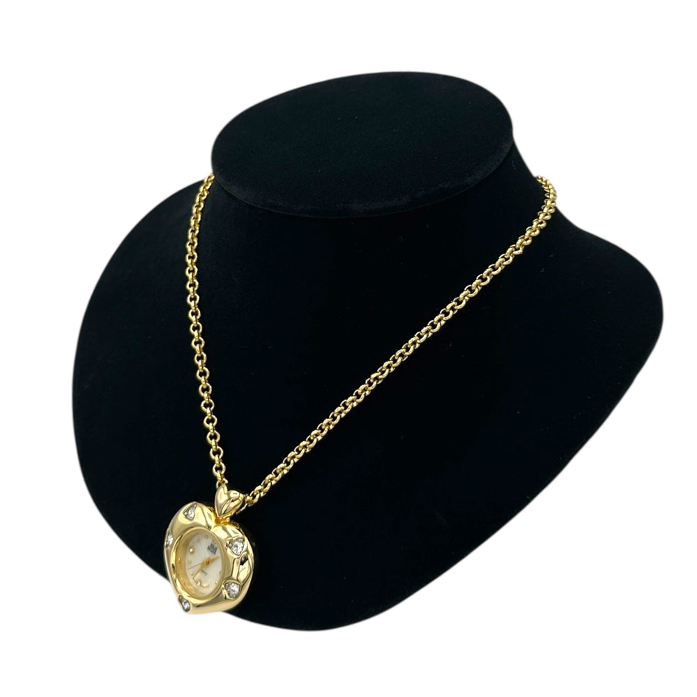 Side view of Vintage Nolan Miller gold heart pendant watch with rhinestone accents on long cable chain displayed on black velvet bust.