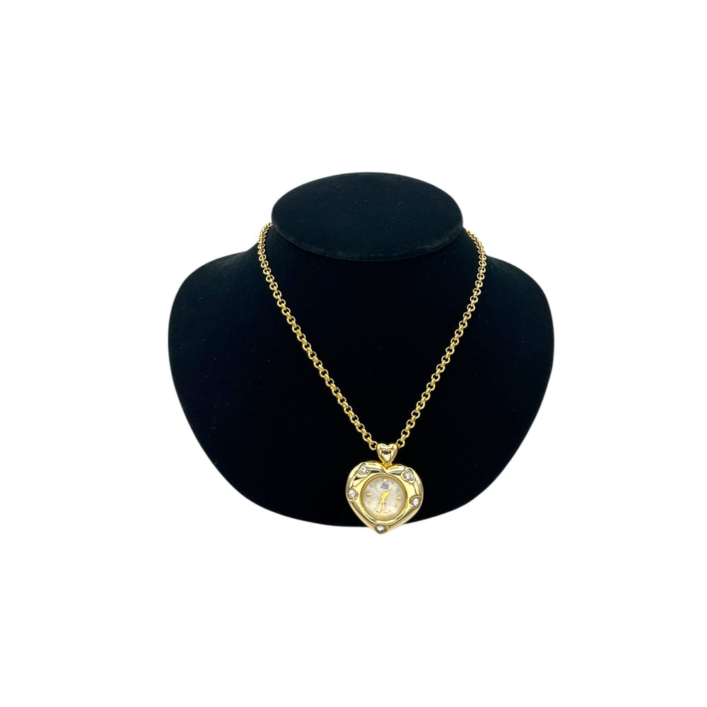 Vintage Nolan Miller gold heart pendant watch with rhinestone accents on long cable chain displayed on black velvet bust.