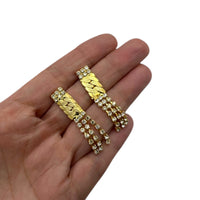 Earrings on hand to show size of Vintage Park Lane gold chevron rhinestone necklace and matching pierced earrings displayed on white background.