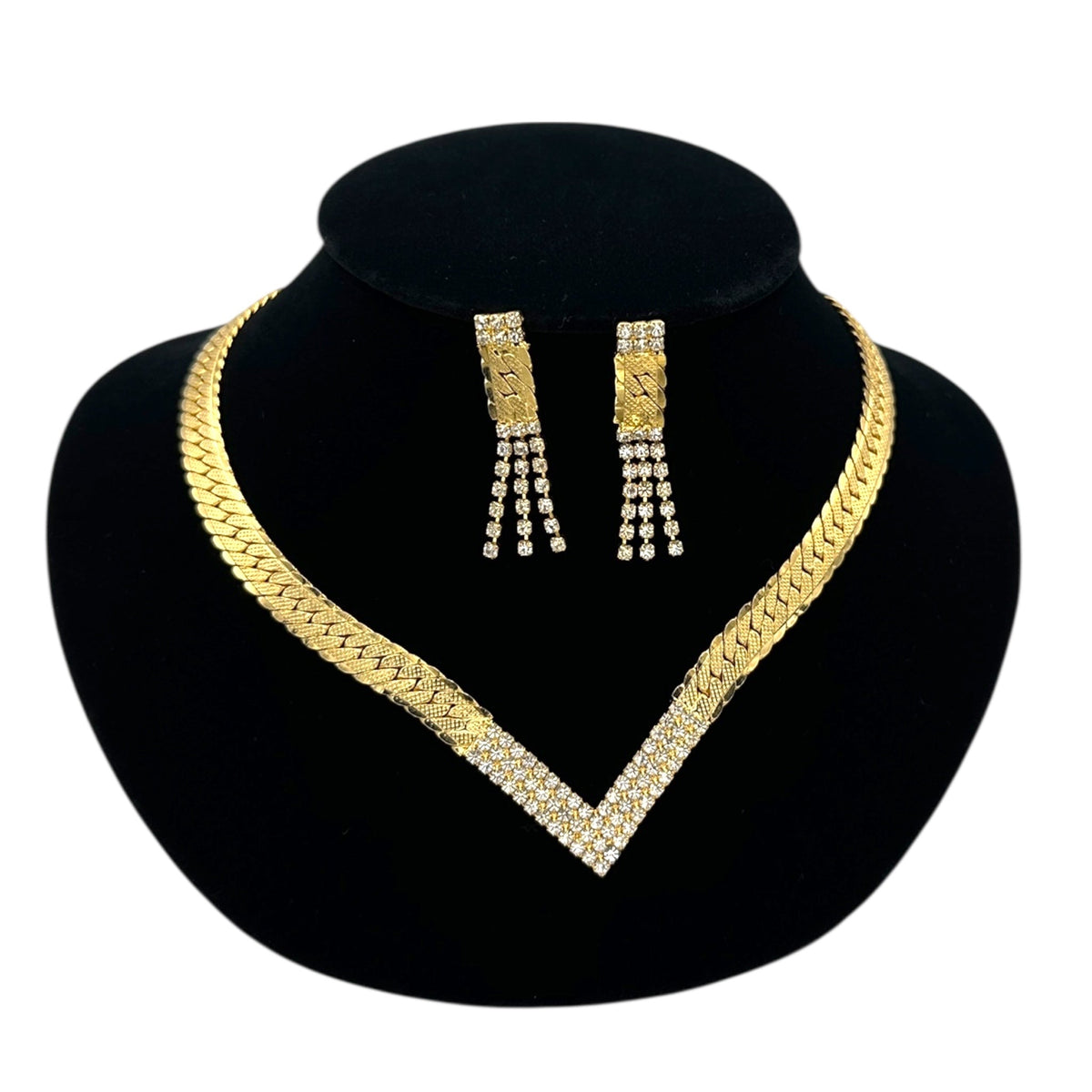 Close up view of Vintage Park Lane gold chevron rhinestone necklace and matching pierced earrings displayed on black velvet bust.