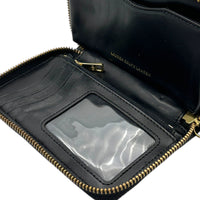 Close up view of interior of Vintage Ralph Lauren RLL black pebbled leather wristlet wallet with gold logo plaque displayed on white background.