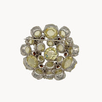 Back view of Schreiner large brooch on white background.