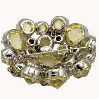 Close up view of back of Schreiner brooch with the signature on white background.