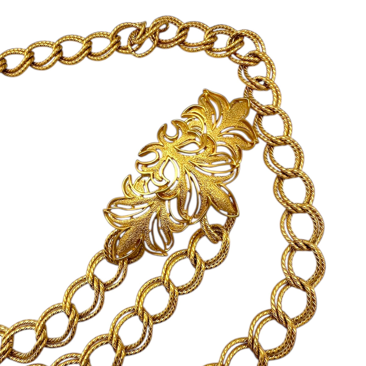 Right side view of Vintage St. John matte gold layered bib belt with ornate leaf accents and curb chain design displayed on white background.
