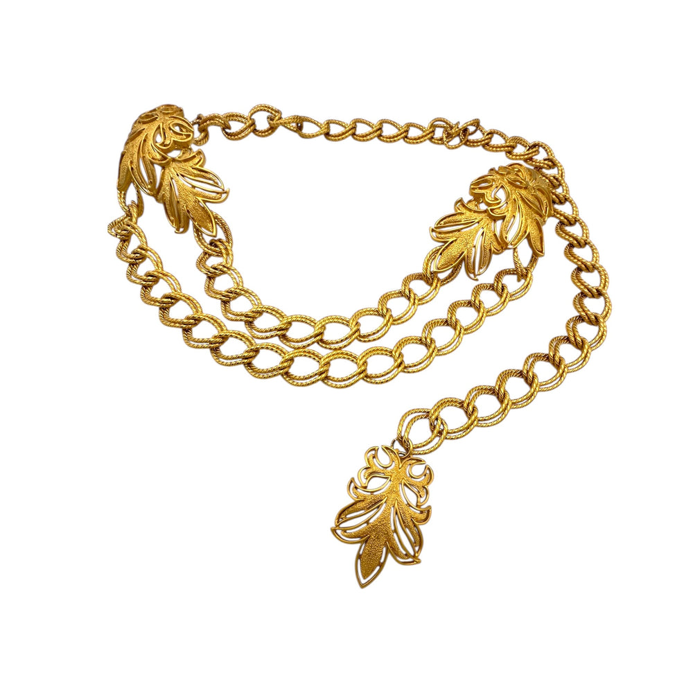 Vintage St. John matte gold layered bib belt with ornate leaf accents and curb chain design displayed on white background.