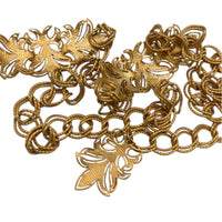 Back view of Vintage St. John matte gold layered bib belt with ornate leaf accents and curb chain design displayed on white background.