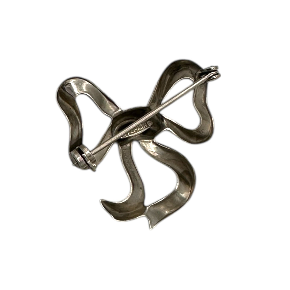 Back view of Vintage sterling silver bow brooch with polished ribbon design, photographed on white background.