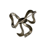 Back view of Vintage sterling silver bow brooch with polished ribbon design, photographed on white background.