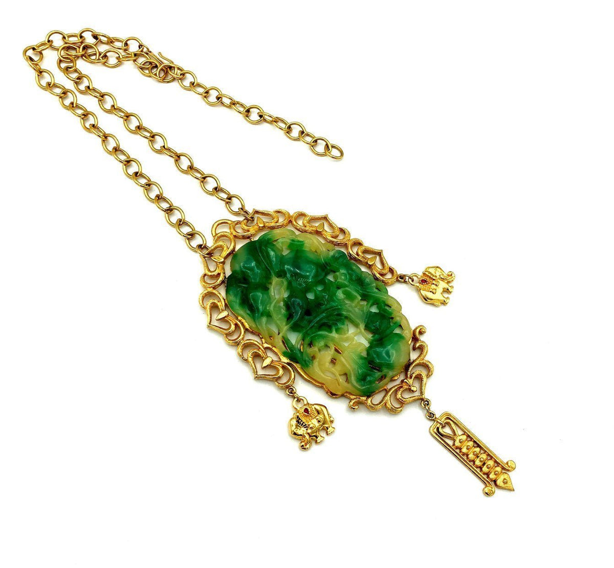 Vendome Asian-inspired vintage pendant necklace with faux carved green jade, gold-tone frame, figural charms, and dangle drop.