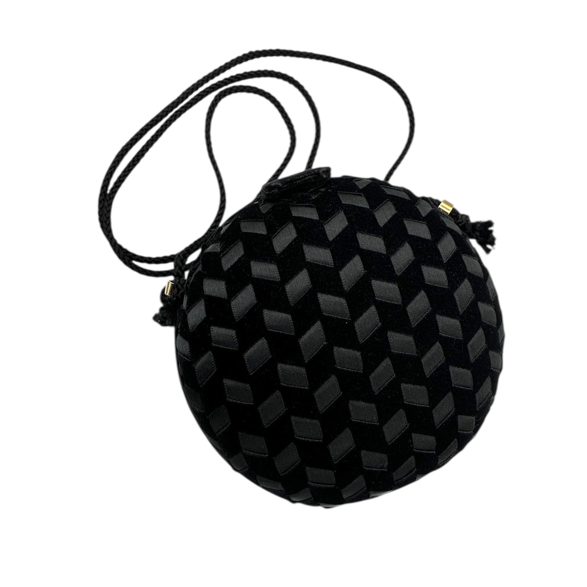 Close up view of Vintage black round velvet and satin weave small crossbody handbag with cord strap displayed on white background.