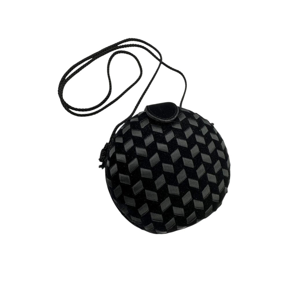 Front view of Vintage black round velvet and satin weave small crossbody handbag with cord strap displayed on white background.
