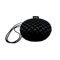 Bottom view of Vintage black round velvet and satin weave small crossbody handbag with cord strap displayed on white background.